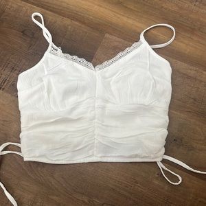 Hollister white crop top with lace and string bows on the side